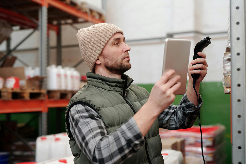 Worker scanning inventory with a tablet